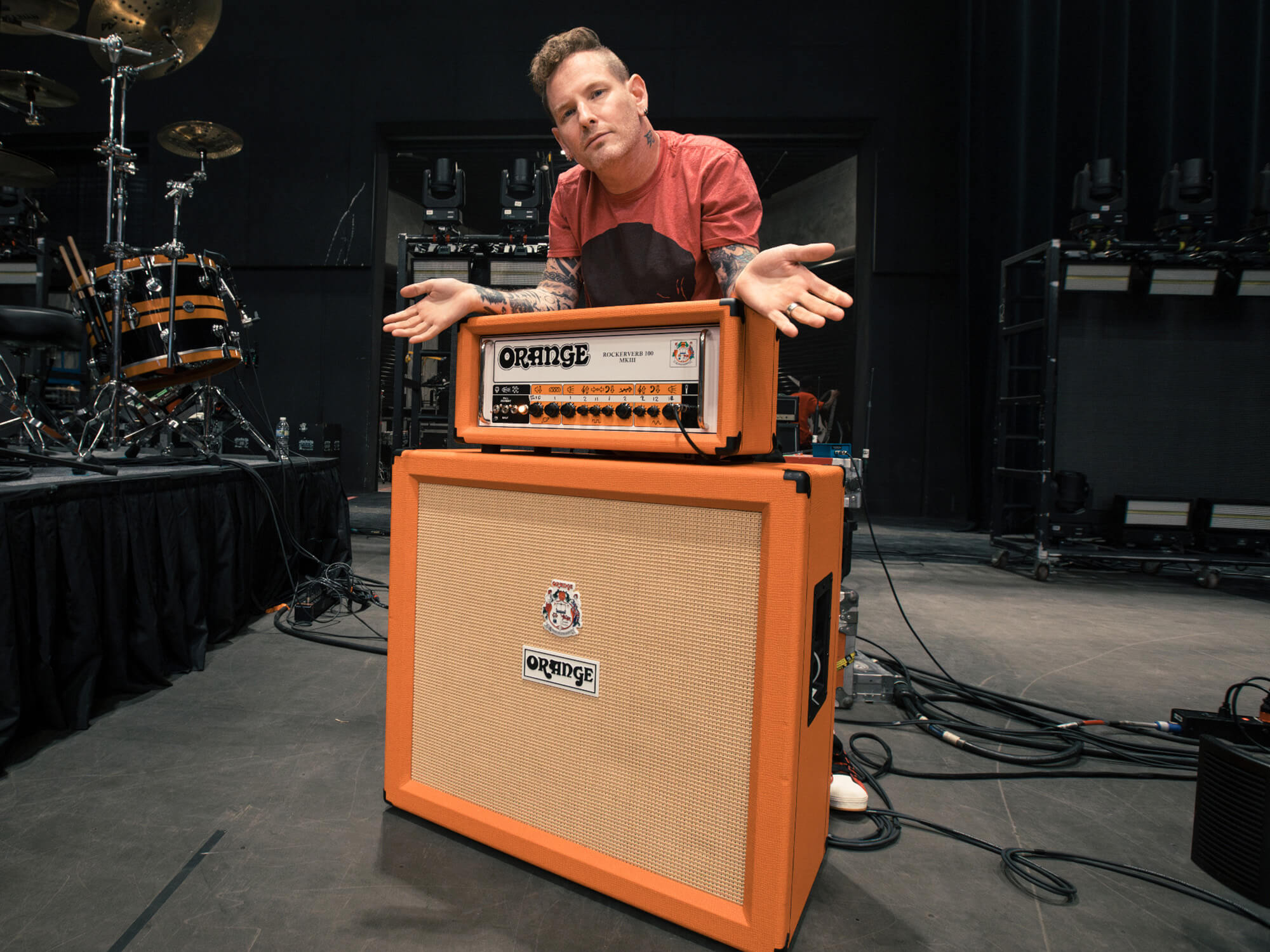 Corey Taylor leaning on his Orange amp head and cabinet