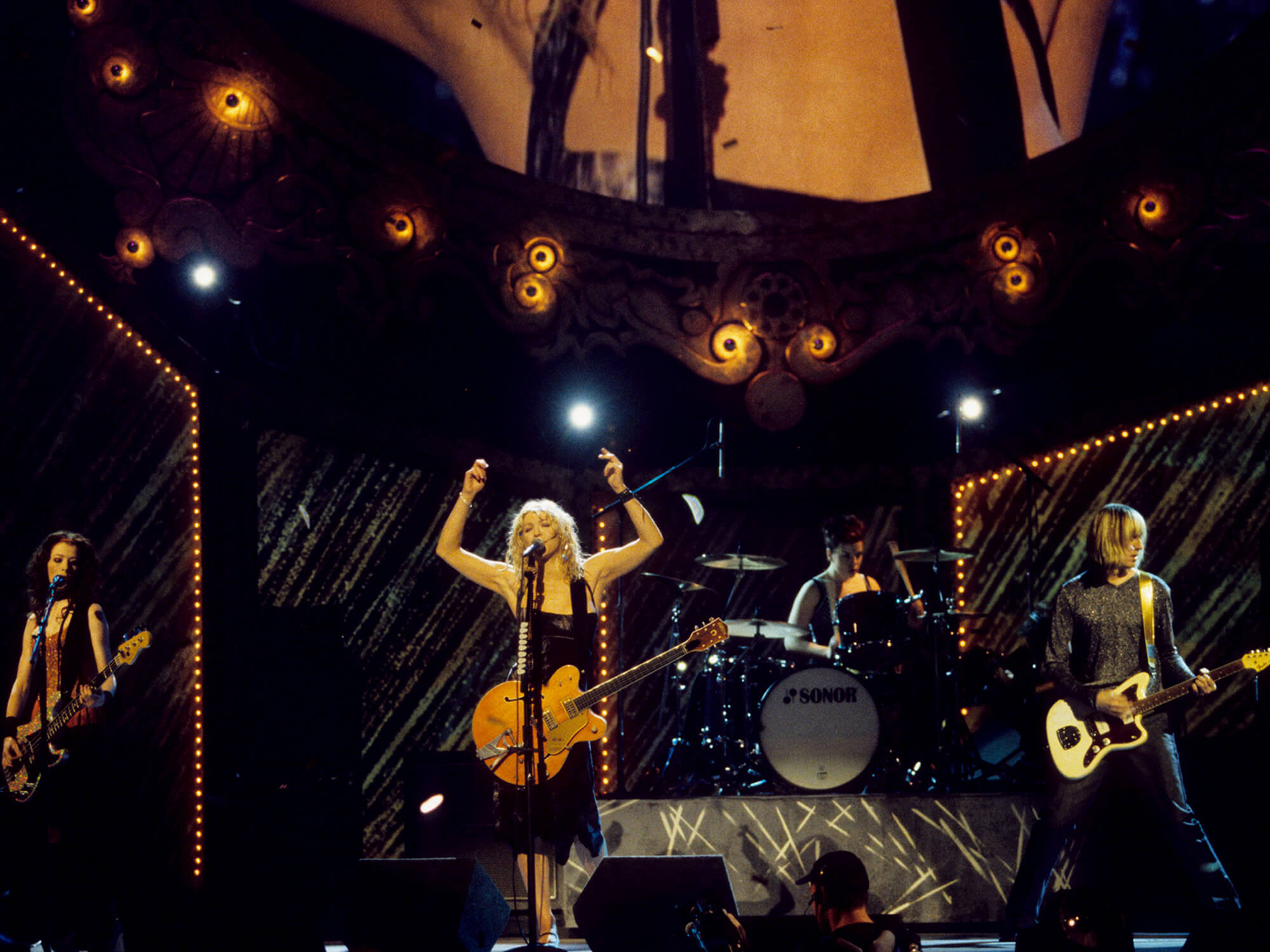 Courtney Love and performing with Hole at The 1998 Billboard Music Awards, photo by Ke.Mazur/WireImage via Getty Images